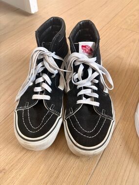 Vans women’s Black and White High-Top Skate Sneakers